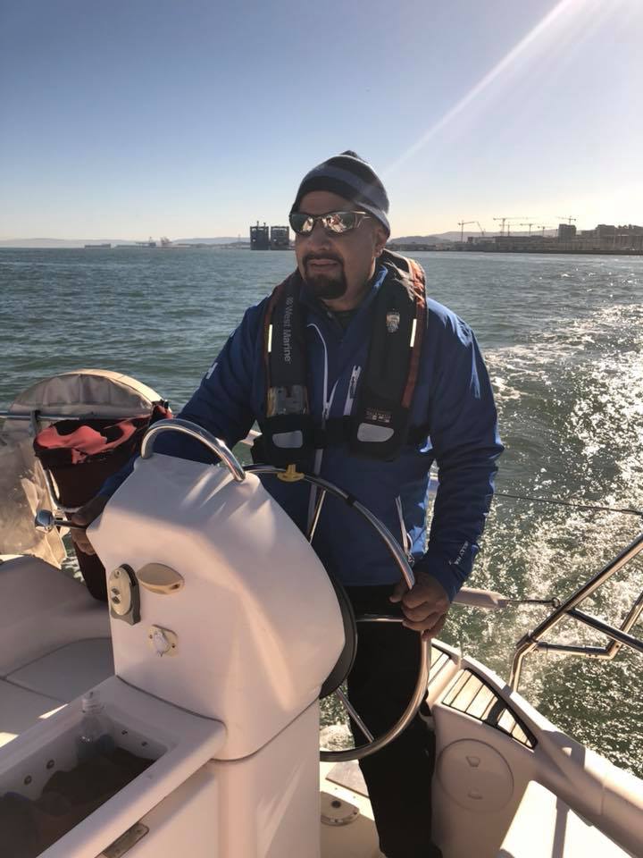 Ted Hannig at the helm of a sailboat